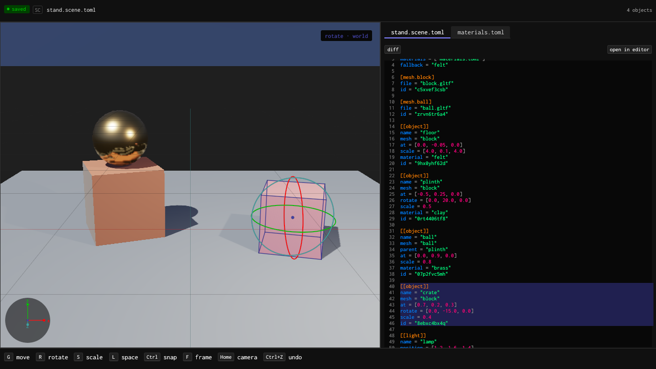 The editor example with the crate selected and the rotate gizmo’s three rings around it, the scene’s TOML beside it with the crate’s table marked, and keycaps for the viewport’s keys along the bottom