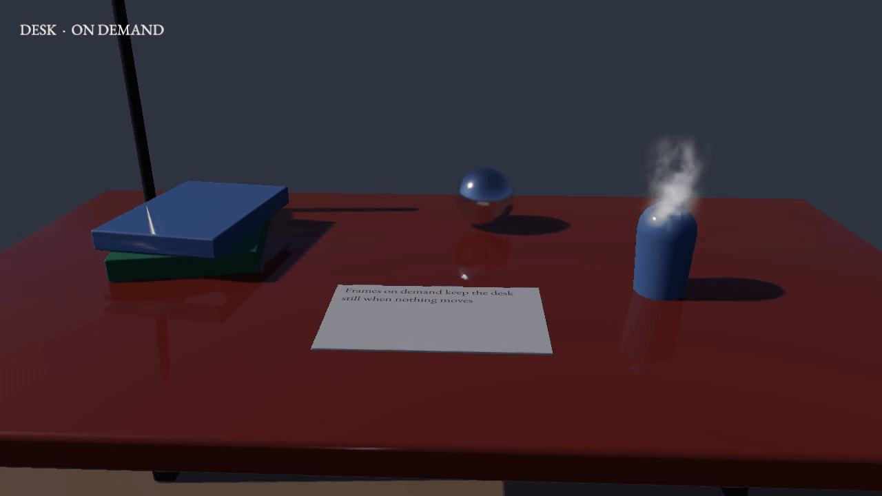 The live renderer drawing the engine’s neutral desk scene while the camera sways around it: a wooden desk with a lamp, a colour chart, a chrome ball, a red box and a white card, with shadows, reflections in the ball and steam rising.